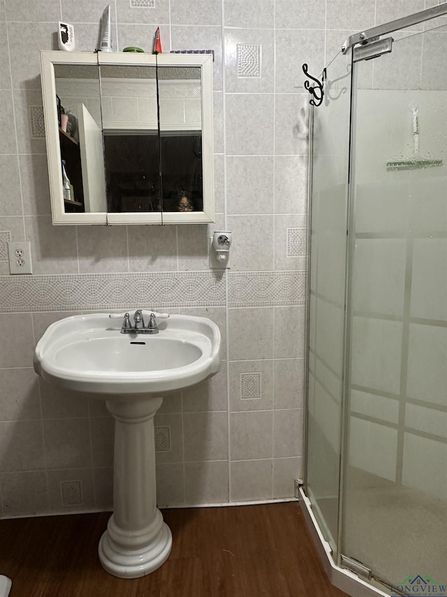 18335 Fm 1716 E, Tatum, TX 75691 - bathroom with wood-type flooring, tile walls, and an enclosed shower