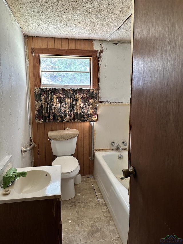 bathroom featuring a tub, vanity, and toilet