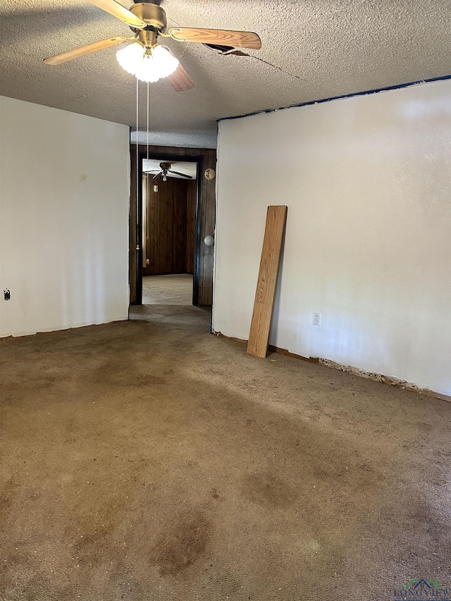 spare room with carpet and a textured ceiling