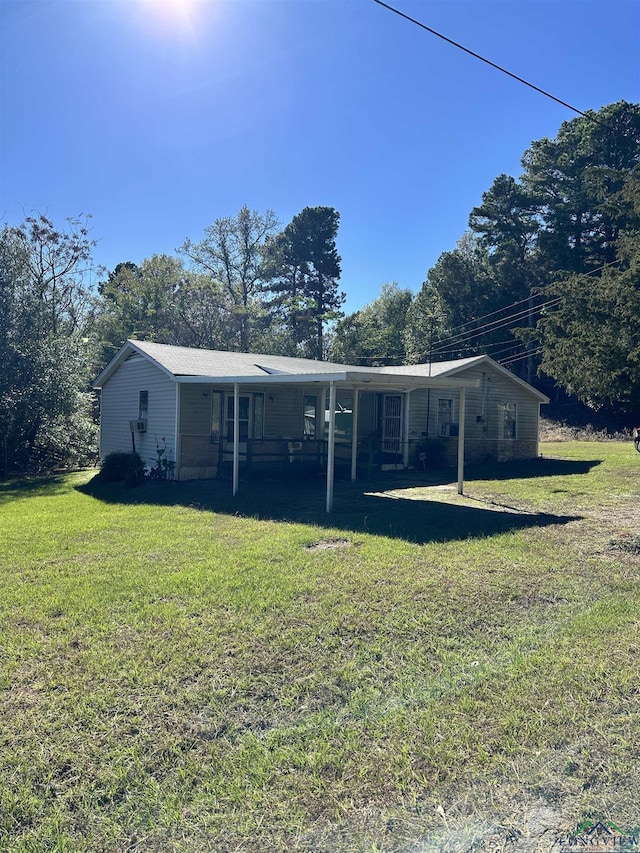 back of property featuring a lawn and a porch