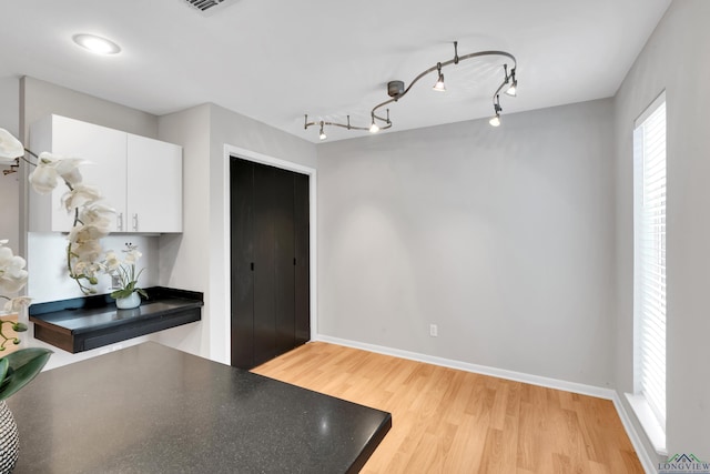 kitchen with white cabinets and light hardwood / wood-style flooring