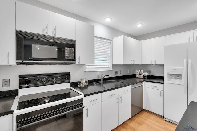 kitchen featuring white cabinetry, sink, dishwasher, white refrigerator with ice dispenser, and range