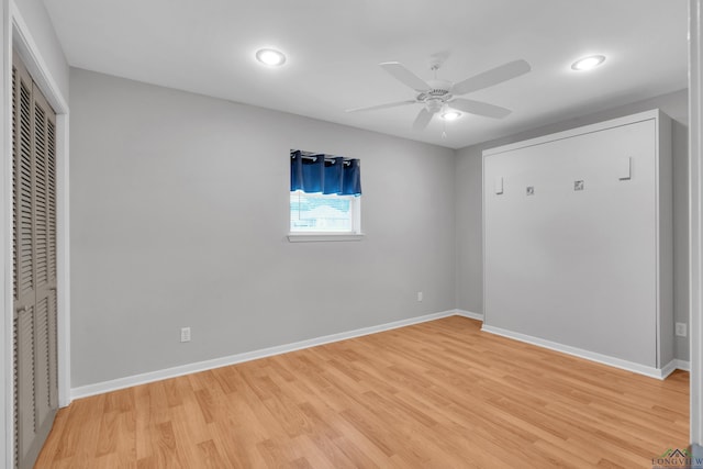 unfurnished bedroom with a closet, light hardwood / wood-style floors, and ceiling fan