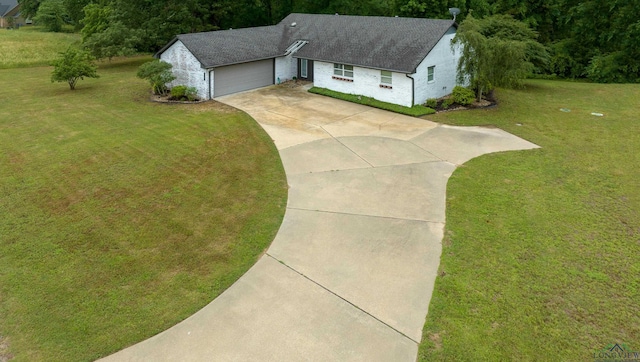 view of front of property with a front yard and a garage