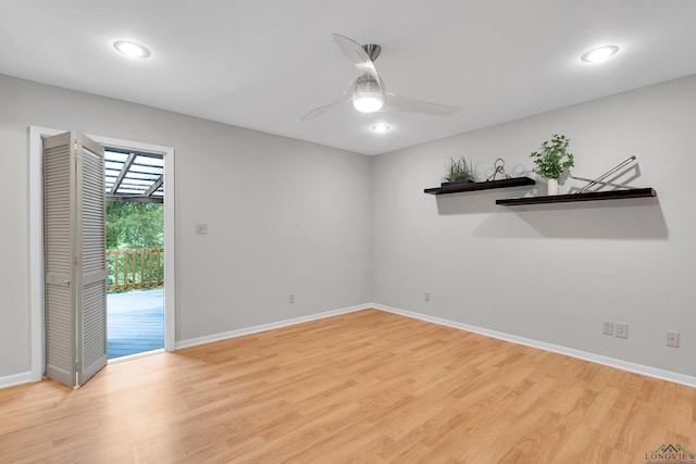 empty room with ceiling fan and light wood-type flooring