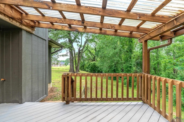 wooden terrace featuring a yard and a pergola