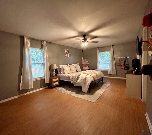 bedroom with ceiling fan and wood-type flooring