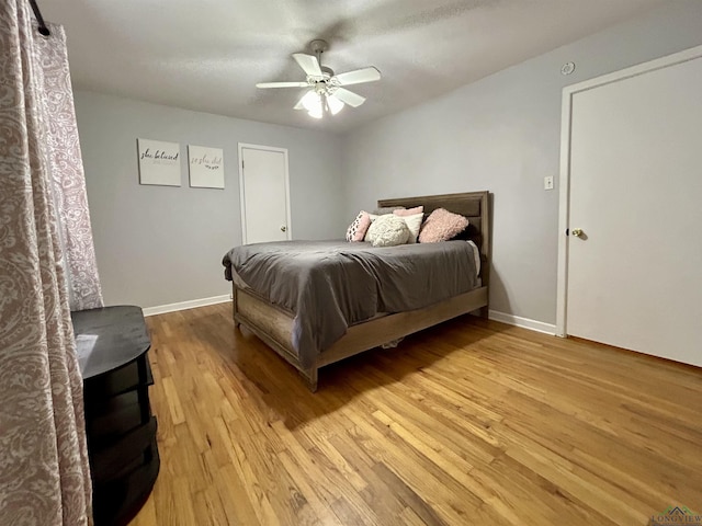 bedroom with ceiling fan and light hardwood / wood-style flooring