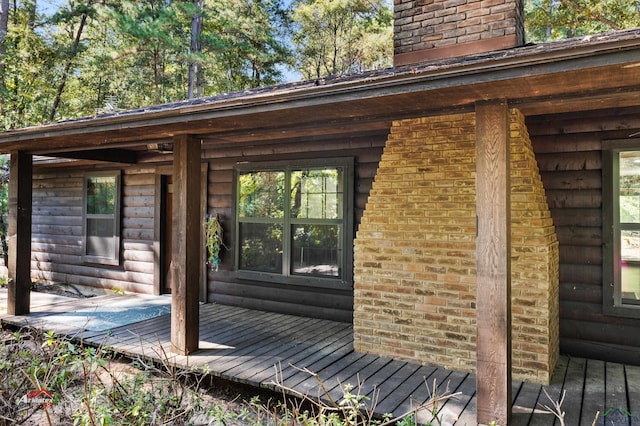 view of exterior entry with a porch