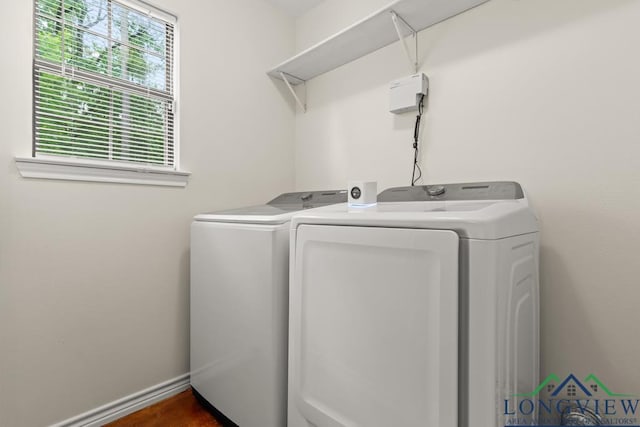 laundry room featuring baseboards, laundry area, and washer and clothes dryer