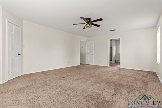 unfurnished bedroom featuring visible vents, carpet flooring, baseboards, and a ceiling fan