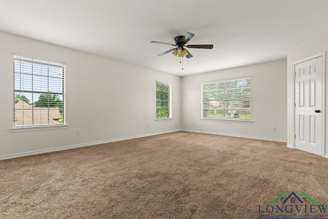 unfurnished bedroom with baseboards, multiple windows, carpet, and ceiling fan