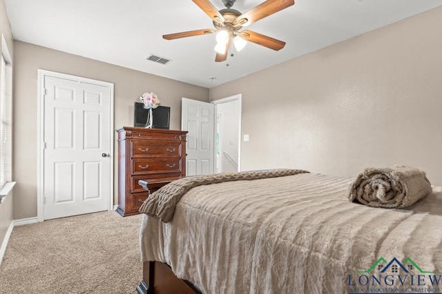 bedroom with baseboards, visible vents, ceiling fan, and carpet