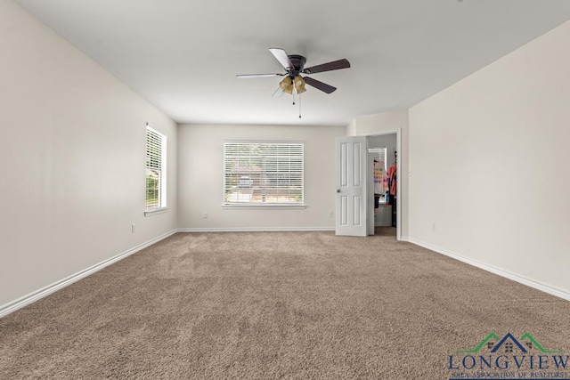 unfurnished room with carpet floors, ceiling fan, and baseboards