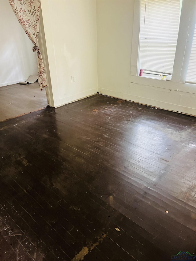 spare room featuring dark wood-type flooring