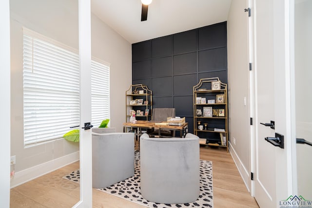 home office featuring light hardwood / wood-style floors and ceiling fan