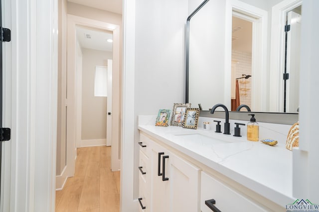 bathroom featuring vanity and hardwood / wood-style floors