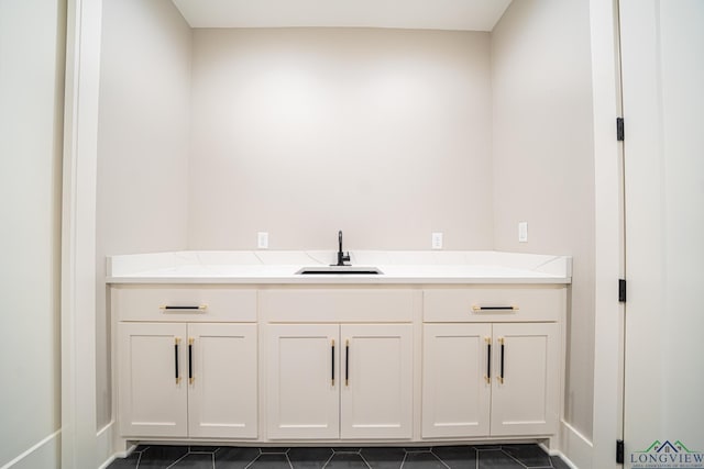 bathroom with sink and tile patterned flooring