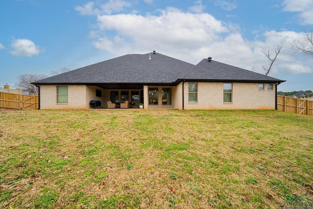 rear view of house with a lawn