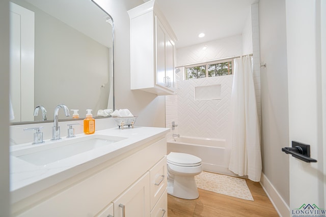 full bathroom with hardwood / wood-style flooring, toilet, shower / bathtub combination with curtain, and vanity