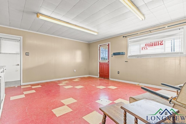 interior space with tile patterned floors, a healthy amount of sunlight, and baseboards