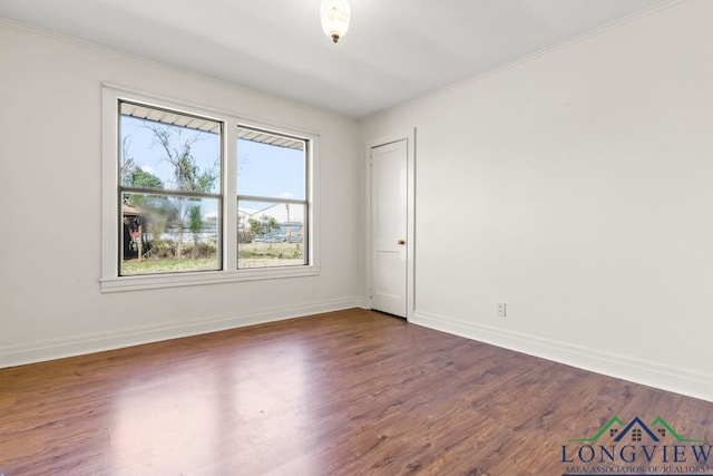 empty room featuring baseboards and dark wood-style flooring