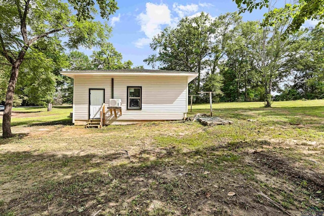 exterior space with cooling unit and a lawn