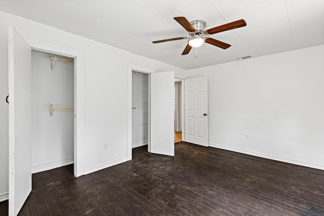 unfurnished bedroom featuring dark hardwood / wood-style floors and ceiling fan