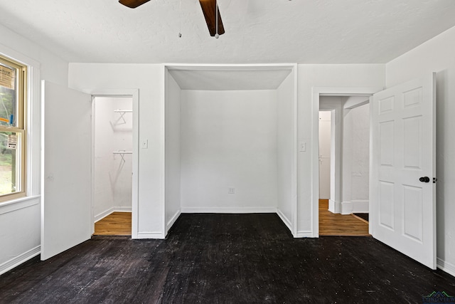 unfurnished bedroom with ceiling fan and dark hardwood / wood-style floors