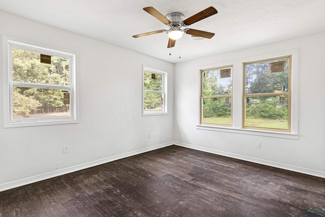 empty room featuring ceiling fan and dark wood-type flooring