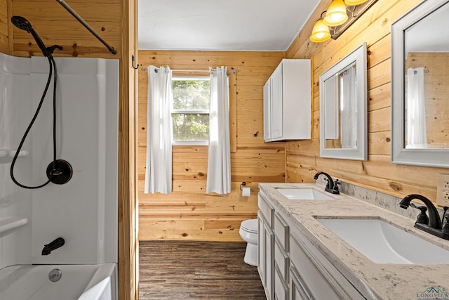 full bathroom featuring vanity, wood walls, bathing tub / shower combination, hardwood / wood-style flooring, and toilet