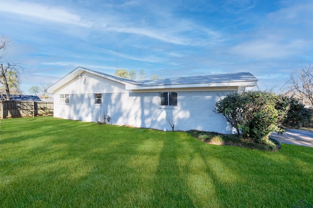 view of side of home with a lawn