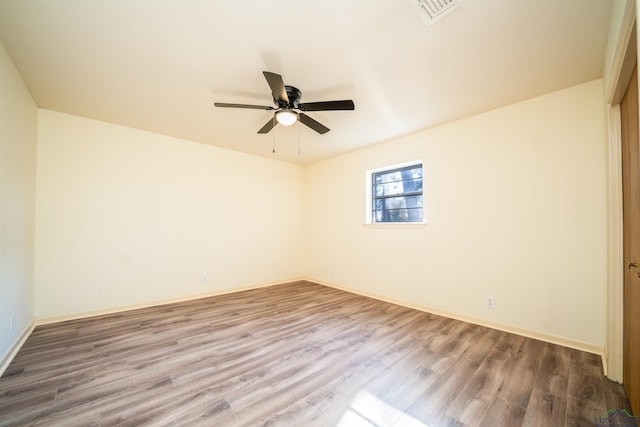 unfurnished room with ceiling fan and hardwood / wood-style floors