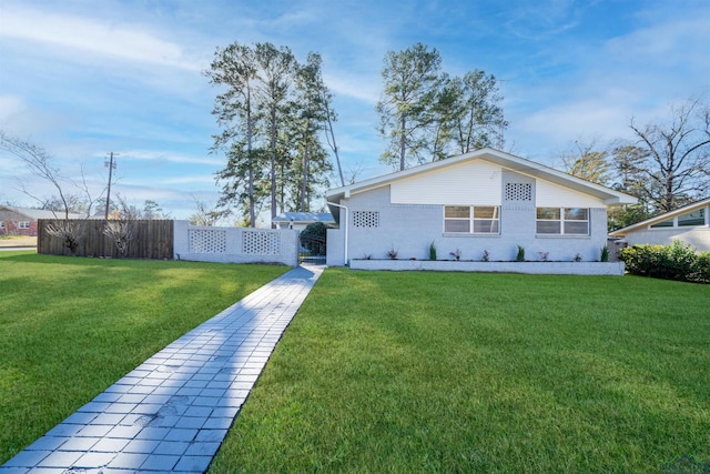 rear view of house featuring a yard