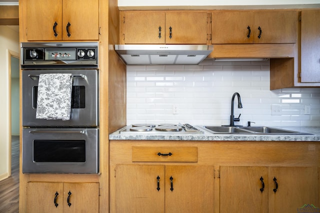 kitchen featuring decorative backsplash, sink, stainless steel double oven, and white gas cooktop