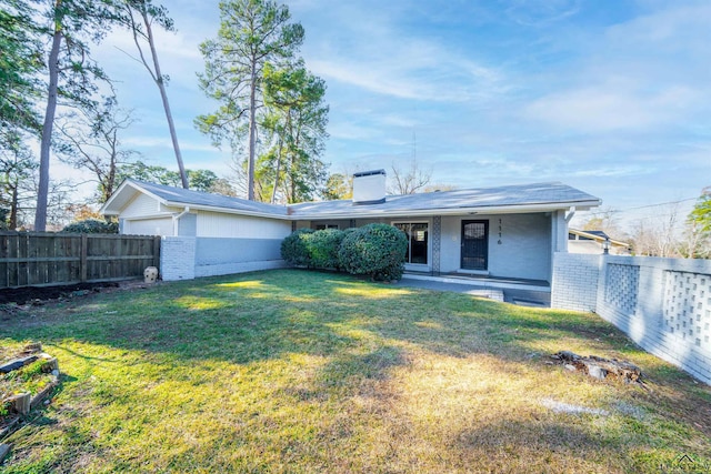 rear view of property with a yard