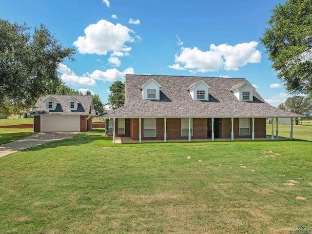 view of front facade featuring covered porch, a front yard, and a garage