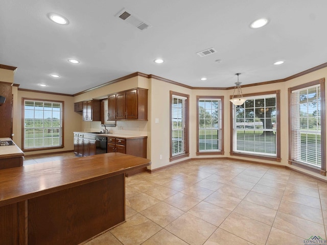 kitchen with dishwasher, light tile patterned floors, decorative light fixtures, and crown molding