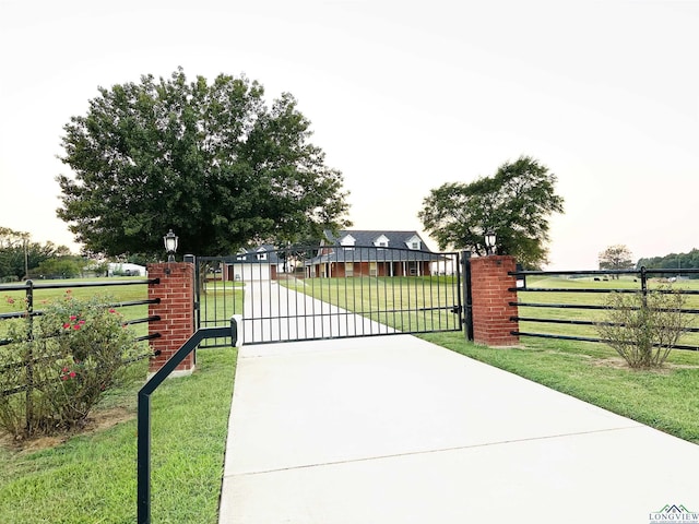 view of gate featuring a yard