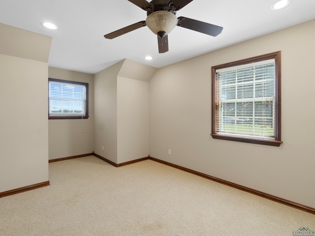 carpeted spare room featuring ceiling fan