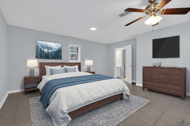 tiled bedroom featuring ensuite bath and ceiling fan