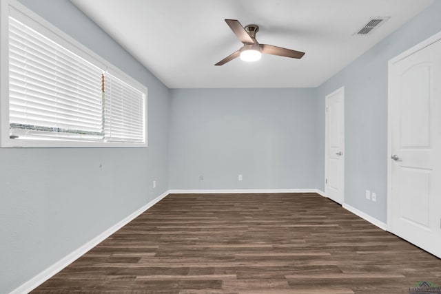 unfurnished room featuring ceiling fan and dark hardwood / wood-style flooring