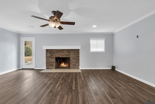 unfurnished living room featuring ornamental molding, a healthy amount of sunlight, and dark wood-type flooring