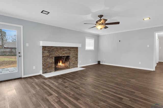 unfurnished living room with crown molding, a fireplace, dark hardwood / wood-style flooring, and ceiling fan