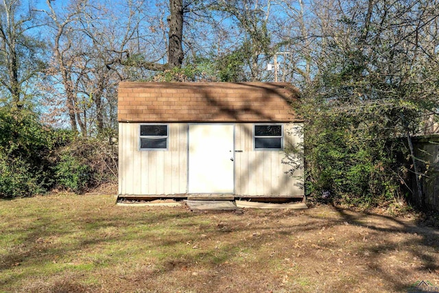 view of outdoor structure featuring a lawn