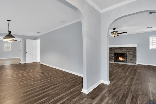 unfurnished living room featuring crown molding, a fireplace, dark hardwood / wood-style floors, and ceiling fan