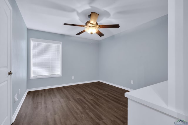 unfurnished room with dark hardwood / wood-style floors and ceiling fan