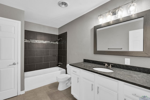 full bathroom featuring tiled shower / bath combo, vanity, tile patterned floors, and toilet