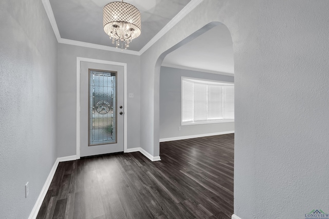 entryway featuring dark hardwood / wood-style flooring, a notable chandelier, and crown molding