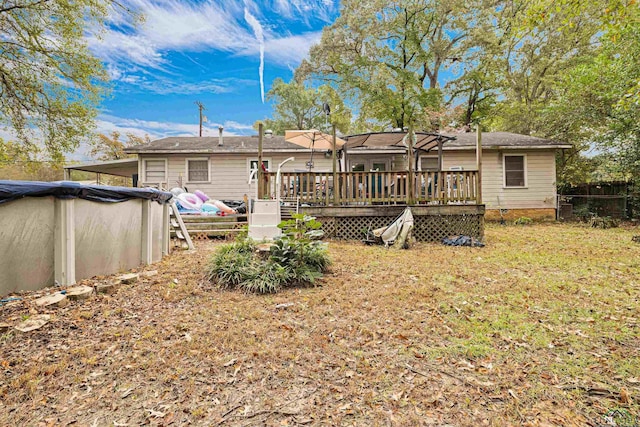 back of property featuring a swimming pool side deck